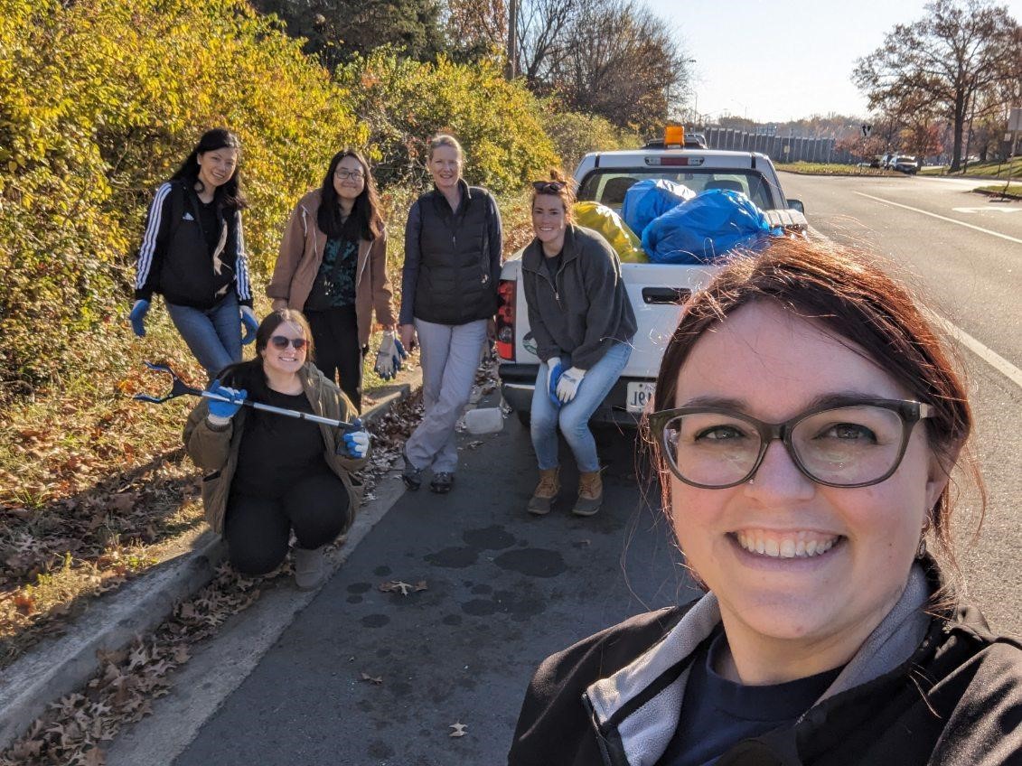 FEEE Members posing in front of trash in back of truck after a successful litter cleanup