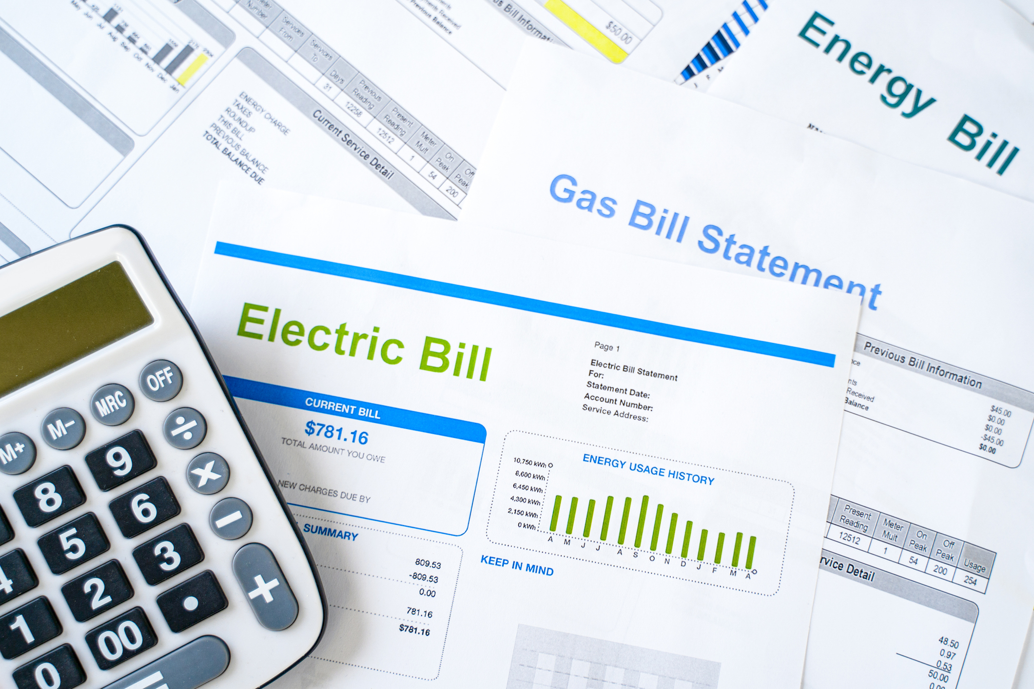 stack of Home electricity expenses and bill statement documents