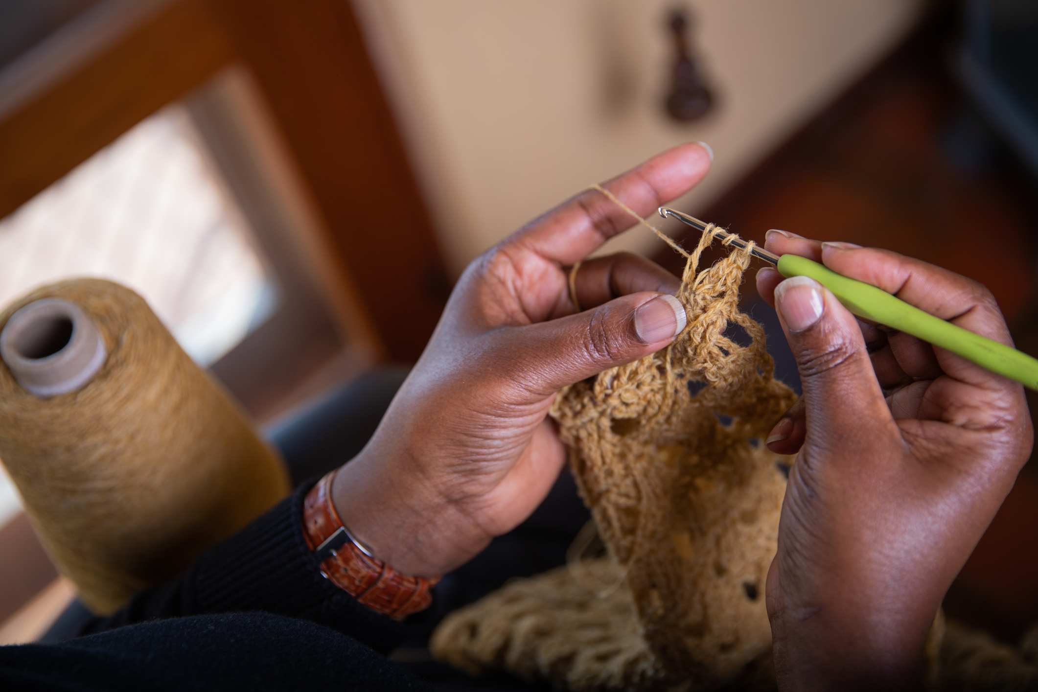 photo of a womans hands crocheting