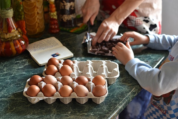 parent and child baking with eggs