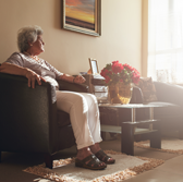 older woman sitting in chair in living room