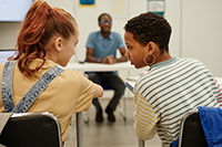 teen girls talking in classroom