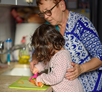 grandmother and young girl in kitchen