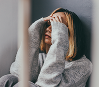 woman with hands covering face