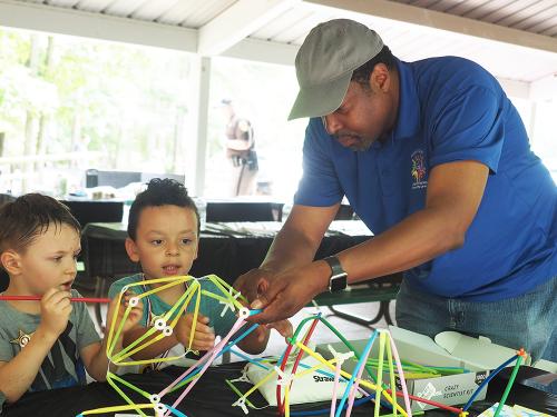 father and two children playing with legos