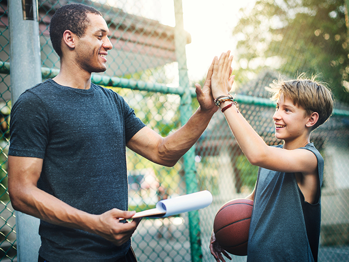 adult and youth outside high fiving