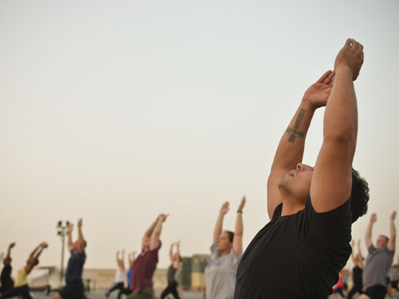 adults outside doing yoga