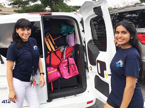 two people standing next to van