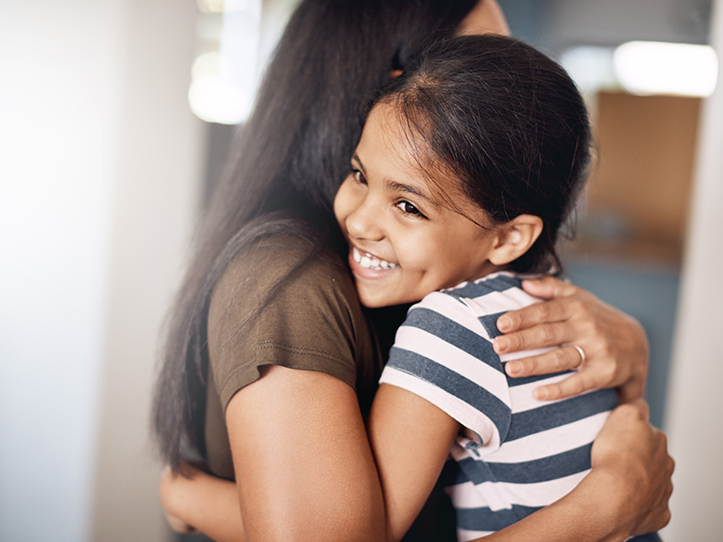 parent hugging child smiling