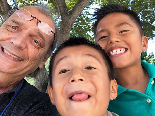 man and two boys smiling