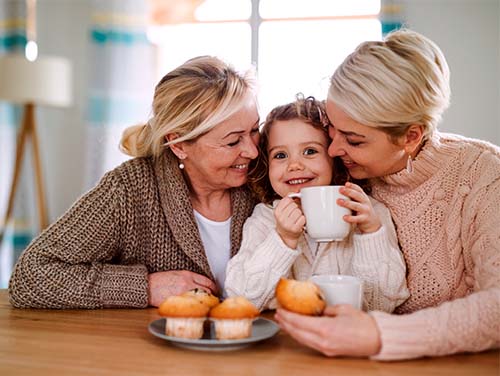 two women hugging a young girl