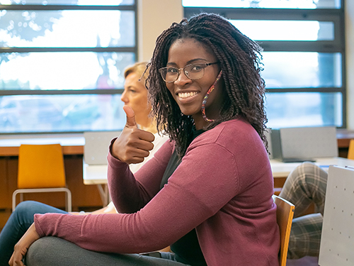 Smiling woman giving thumbs up