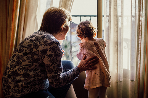 woman and child looking out window