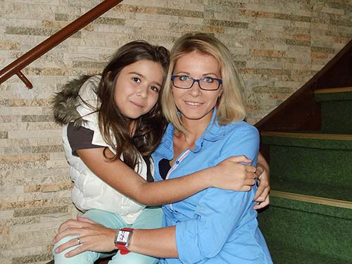 girl sitting on woman's lap