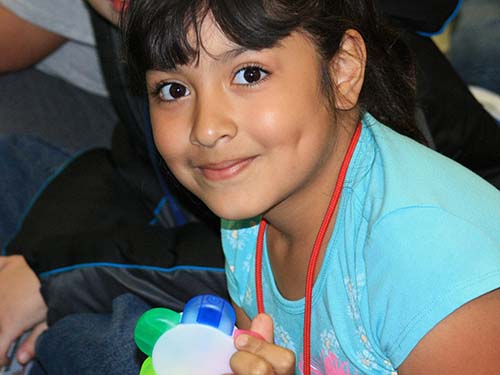 young girl smiling and sitting (this is a stock photo with posed model)