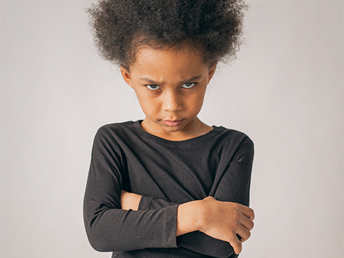 angry child with arms crossed