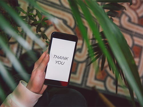 cell phone with thank you on screen