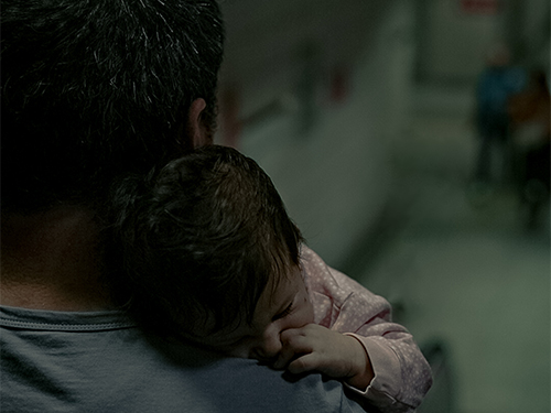 baby sleeping on man's shoulder