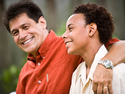 Father with arm around son's shoulder