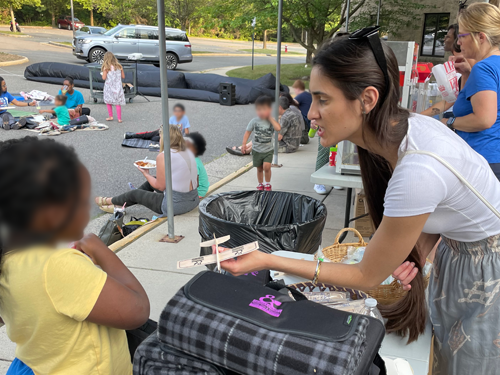 woman giving child a toy plane