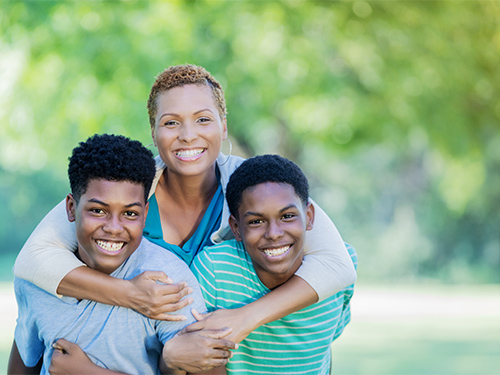 mother hugging sons