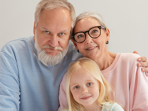 older man and woman with child in lap