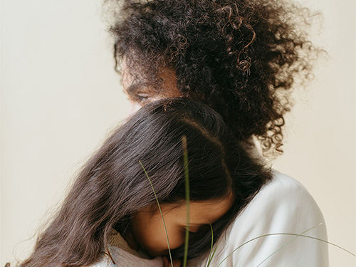 woman hugging child