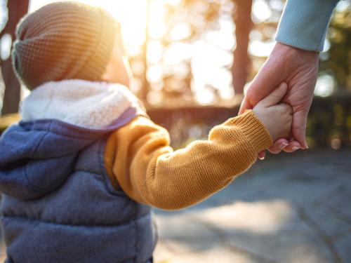 child holding adult hand