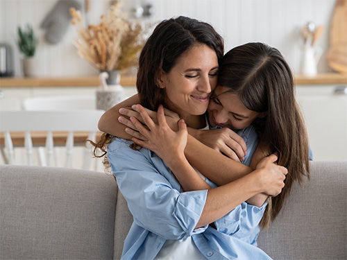 daughter hugging mother 