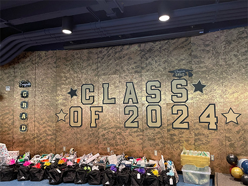 gift bags on table under Class of 2024 sign