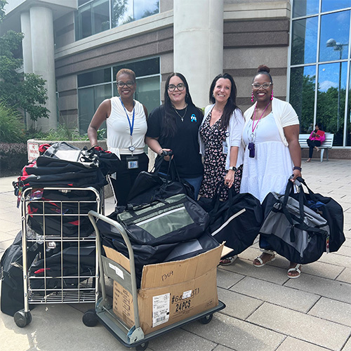 Harlee with DFS staff and donations