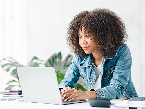 teen girl looking at laptop