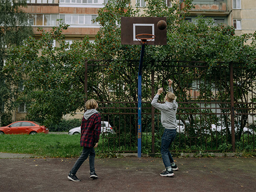 two boys playing basketball