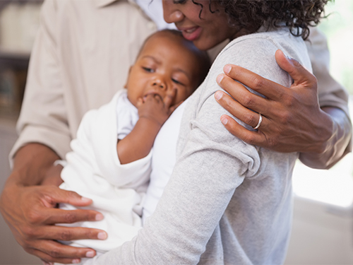 woman and man holding infant