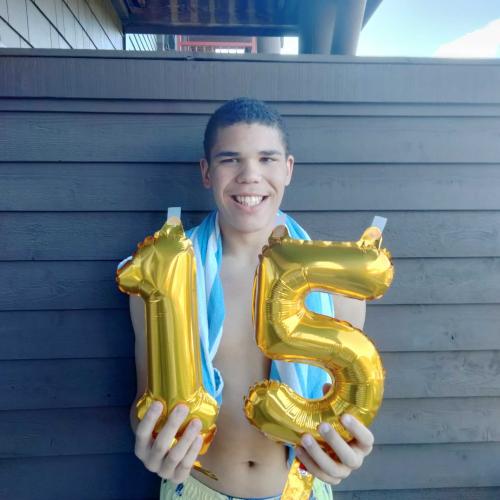 Adame holding 15 ballons