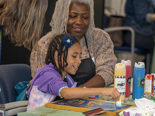 mother daughter painting at adoption event