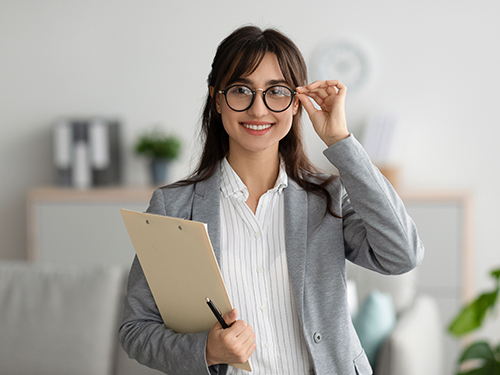 business woman holding clipboard in home
