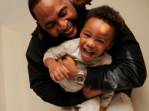dad hugging child smiling
