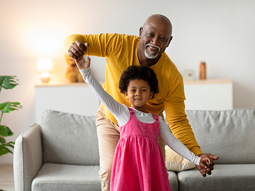 grandfather dancing with granddaughter