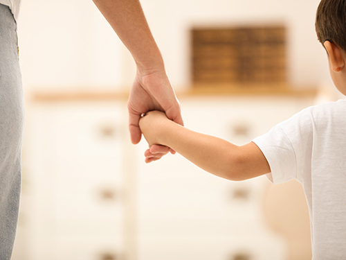 mother holding child's hand