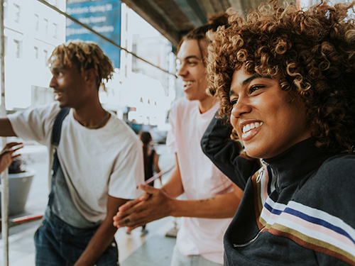 three smiling young adults