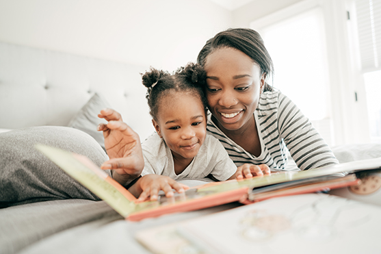 parent and child looking at books together