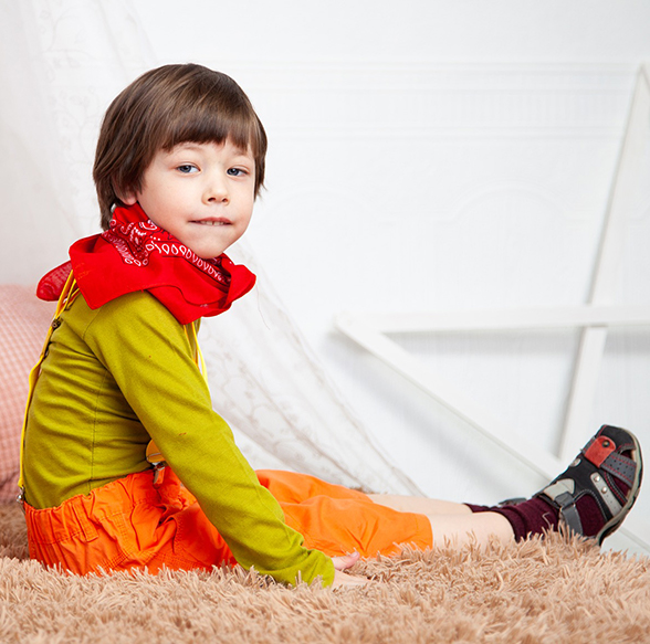 child wearing outfit with bandana sittin