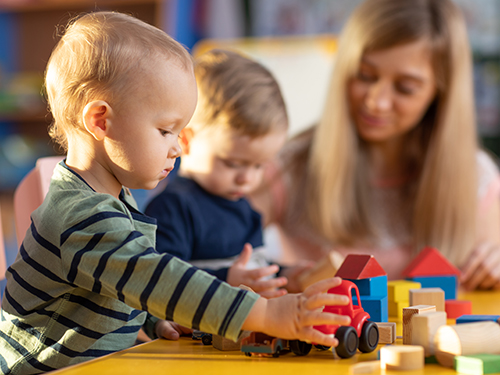 children woman playing with toys