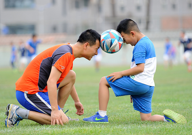 father and son being silly with soccer ball