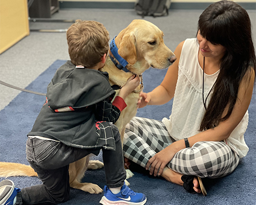 child and adult petting Rylynn