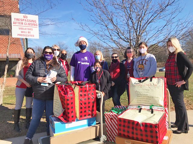 Leidos group photo outside with gifts