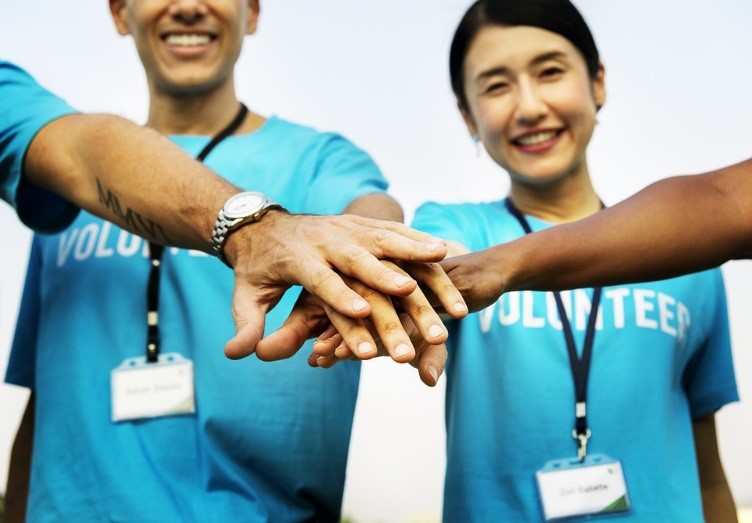 volunteers touching hands