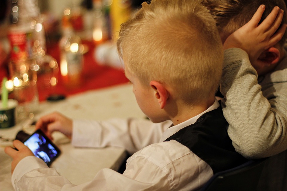 children looking at cell phone