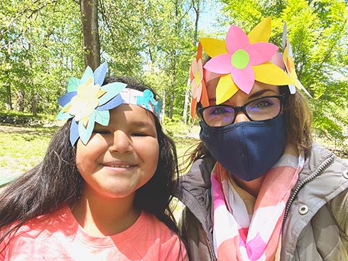 child and adult wearing handmade head pieces